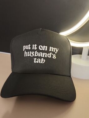 Put It On My Husband's Tab Black Embroidered Trucker Cap